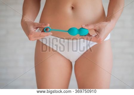 Faceless Woman In White Panties Holding The Kegel Trainer For Strengthening The Intimate Muscles Of 