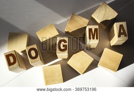 Dogma Word Written In Wooden Cube And White Background.
