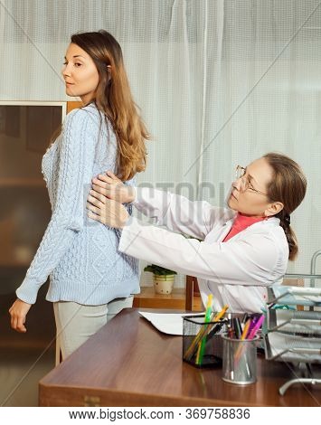 Doctor Touching Behind Of Young Patient And Diagnostics In Clinic