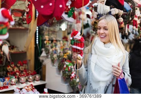 Smiling Young Blonde Female Shopping At Festive Fair Before Xmas