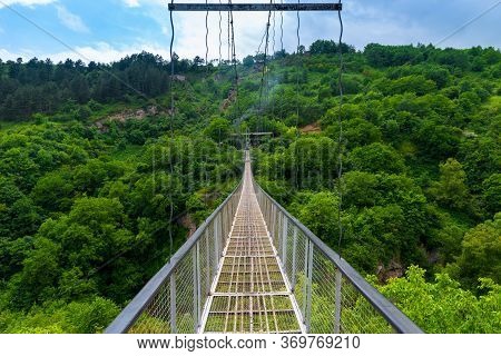 Suspension Metal Bridge Over The Gorge In The Mountains Of Armenia, Khndzoresk Landmark