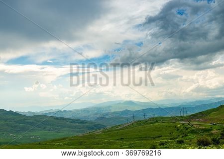 Panoramic View Of The Picturesque Landscape Of Armenia - Mountains, Fields And Clouds