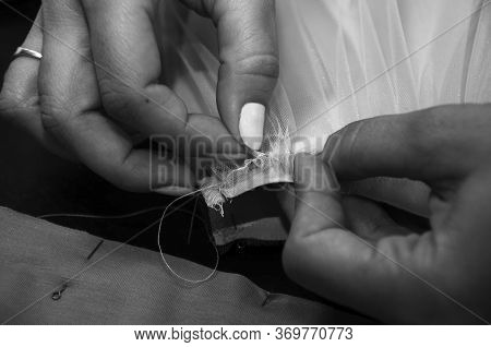 A Woman Attaches A Cambric Cloth To Satin Fabric. Seamstress Collects Fabric Closeup. Small Business