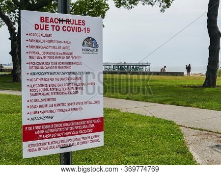 NORWALK, CT, USA - June 4, 2020: Informative sign on Calf Pasture Beach  during COVID-19 Pandemic