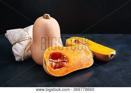 Nutmeg Pumpkin Dark Background. Concept Of Fresh Vegetables, Grocery Delivery, Eco-friendly Packagin