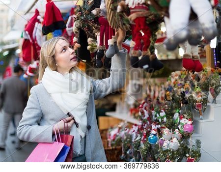 Portrait Of Female Customer Near Counter With Xmas Gifts