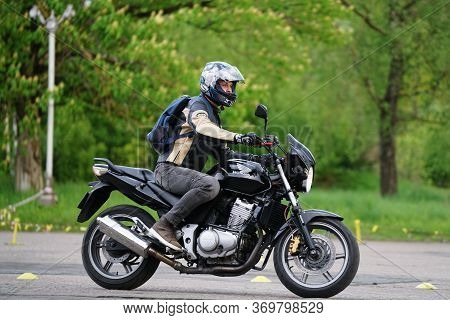25-05-2020 Riga, Latvia. Motorcyclist Goes On Road. A Motorcyclist Learns To Control A Motorbike.