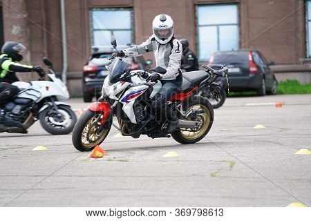 25-05-2020 Riga, Latvia. Motorcyclist Goes On Road. A Motorcyclist Learns To Control A Motorbike.