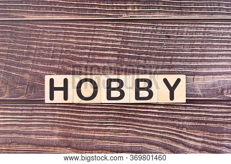 Hobby Word Written On Wooden Blocks With A Wooden Background