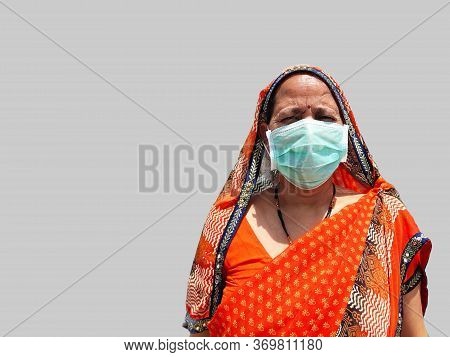 Indian Woman In Saari Wearing Face Mask For Corona Virus Protection.