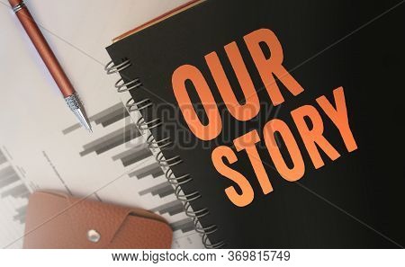 Our Stroy Words Written On A Cover, Of Copybook, Orange On Black. Business Story Concept. Selective 