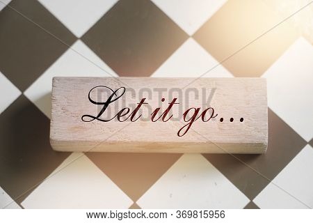 Let It Go Wooden Sign With A Chess On Background. Phylosophy Forgiveness Concept
