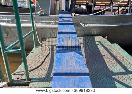 Blue Narrow Wooden Board For Passage On The Ship. The Old Gangway Of The Ship. The Concept Of Unreli