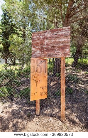 Wooden Signs In English, Hebrew And Arabic With A Drawn Map And Opening Hours Of The Monastery Of La