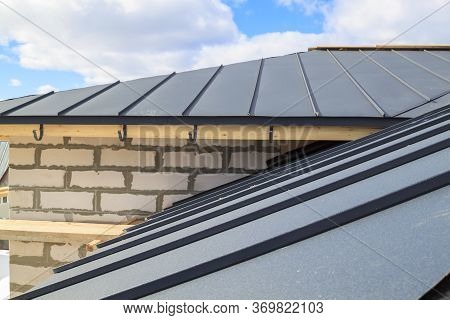 Close Up View Of Scaffolding And House Under Construction With Grey Folding Roof On Waterproofing La