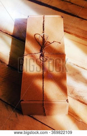 The Brun Squared Present Box On A Wooden Background.