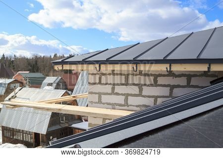 Close Up View Of Scaffolding And House Under Construction With Grey Folding Roof On Waterproofing La