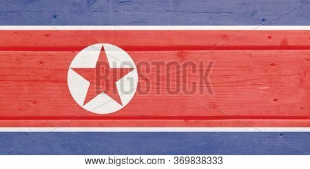Korea, D.p.r. Flag Painted On Wood Plank Background. Brushed Natural Light Knotted Wooden Board Text