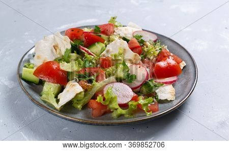 Vegan Fattoush Salad In A Gray Plate On A Gray Background. Close Up. Levantine Salad Fattoush, Which