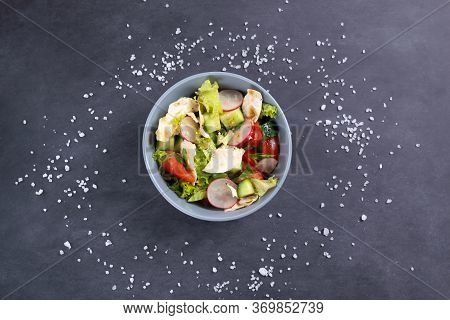 Fattoush Vegetarian Salad In A Gray Bowl Against Black Background. Top View. Levantine Salad Fattous