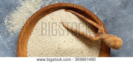 Raw Uncooked Fonio Seeds With A Spoon On Grey Background  Top View