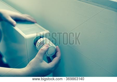 Woman Changing The Temperature On Radiator By Temperature Controller, Increase Or Decrease The Price
