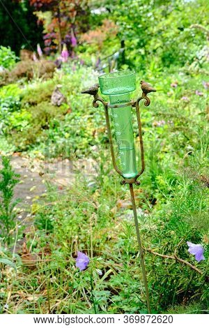 Rain Gauge Filled With Water After Rain In Garden With Selective Focus. Water Measurement In The Gar