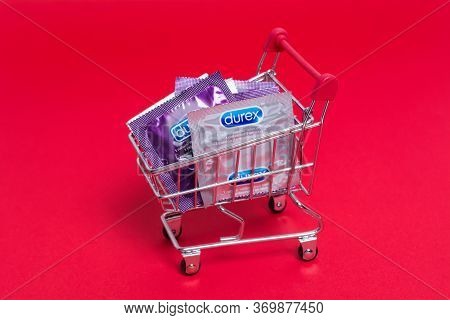 Kyiv, Ukraine - 21 May 2020: Durex Condoms In A Shopping Trolley On The Red Background. Durex Elite 