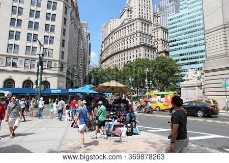 New York, Usa - July 6, 2013: People Walk By Souvenir Stands In Lower Manhattan In New York. As Of 2