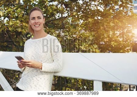 Beautiful Woman Searching Inform Ation Via Cell Telephone During Walking Outdoors