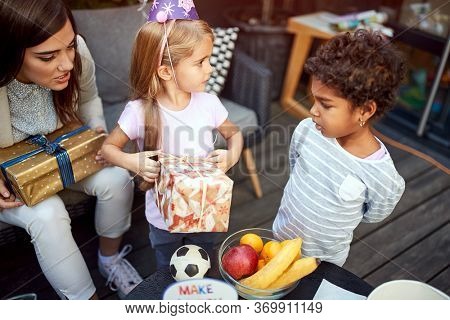 Mom with kids on birtday party outdoor