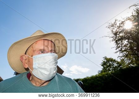 Elderly Man Wearing Face Mask As Coronavirus Protection,hampshire,united Kingdom.