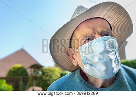 Elderly Man Wearing Face Mask As Coronavirus Protection,hampshire,united Kingdom.