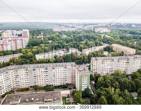 Aerial View Of Town With Socialist Soviet Panel Building At Cloudy Day. Buildings Were Built In The 