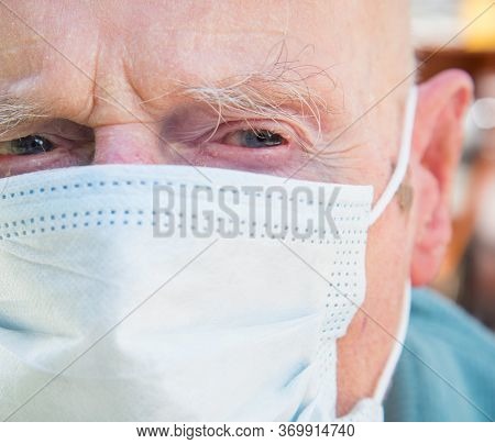 Elderly Man Wearing Face Mask As Coronavirus Protection,hampshire,united Kingdom.