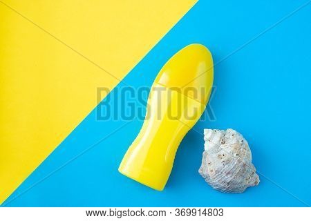 Yellow Bottle With A Skin Care Product On A Yellow And Blue Background. Branding Mockup. Skin Protec