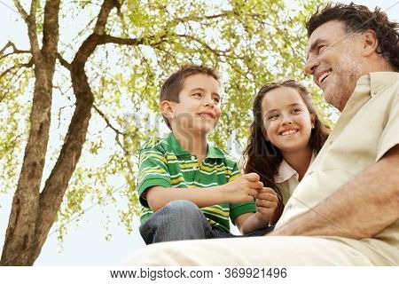 Portrait of senior man having fun having fun with grand daughter and grand son