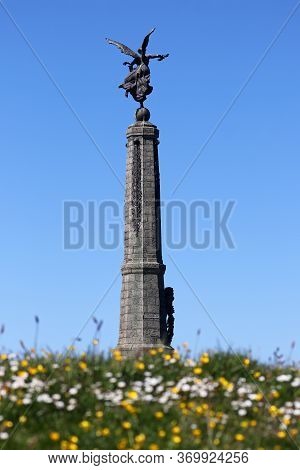 The Aberystwyth War Memorial With Daisies And Dandelions Growing In The Foreground