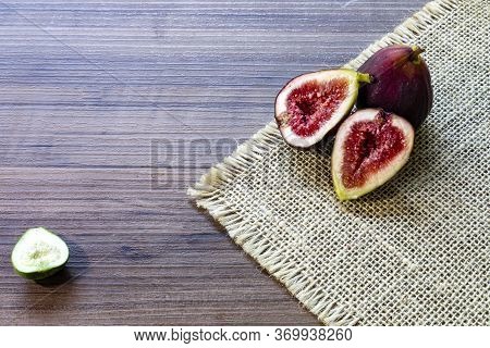 Figs, Green Leaves On Rustic Wooden Background