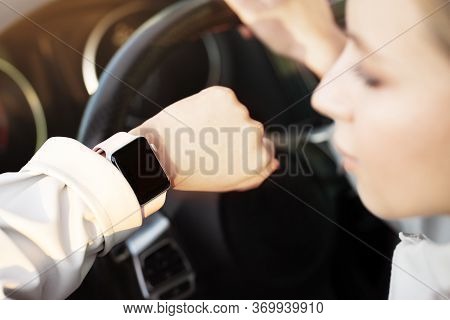 Close Up Woman Looking On Hand With Smart Watch, Empty Screen, Sitting In Car As Driver, Holding Ste