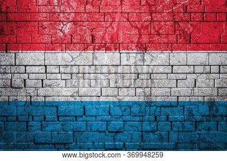 National Flag Of Luxembourg On Brick  Wall Background.the Concept Of National Pride And Symbol Of Th