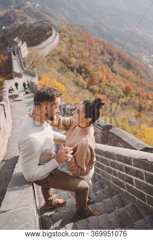 Beautiful Young Couple Showing Affection On The Great Wall Of China