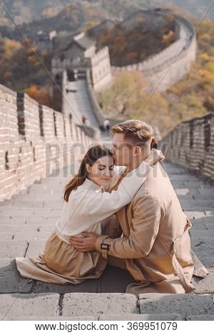 Beautiful Young Couple Showing Affection On The Great Wall Of China