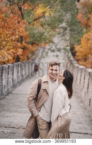 Young Couple Kissing At The Great Wall Of China