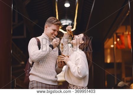 Newlywed Couple Eating Noodles With Chopsticks In Shanghai Outside A Food Market