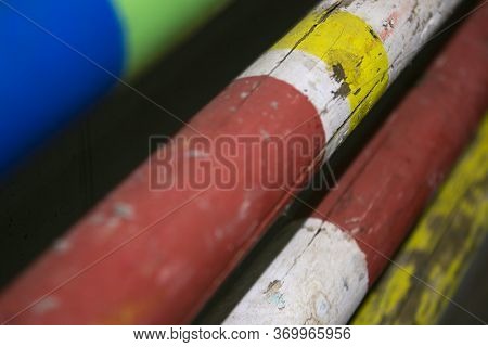 Stack Of Equestrian Jumping Poles In Various Colors