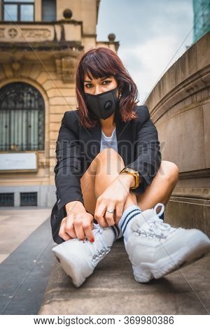 A Young Brunette With A Face Mask From The Coronavirus Pandemic. Deconfinement After Covid-19