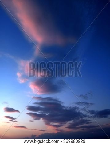Colorful Clouds In The Blue Sky Refelecting The Light Of Sun