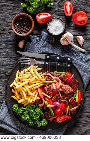Lomo Saltado, Peruvian Dish Of Stir-fried Slices Of Beef Sirloin, Onions, Yellow Peruvian Chilis, An
