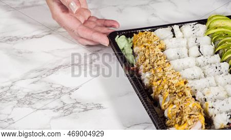 Pre-packaged Variety Of Sushi And Sushi Rolls In A Plastic Tray.